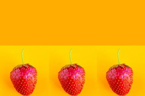 Strawberry pattern on bright orange background, copy space for the text Stock Photos