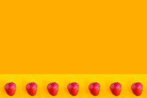 Strawberry pattern on bright orange background, copy space for the text Stockfoto's