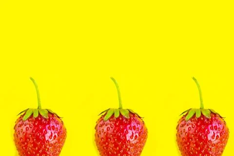 Strawberry pattern on bright yellow background, copy space for the text Stock Photos