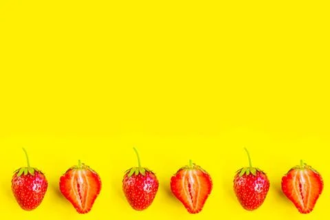 Strawberry pattern on bright yellow background, copy space for the text Stock Photos