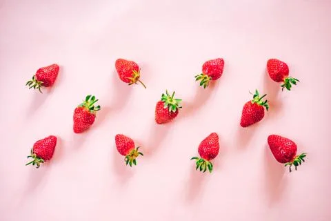 Strawberry pattern on the light pink background. Stock Photos