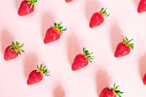 Strawberry pattern on the light pink background. Stock Photos