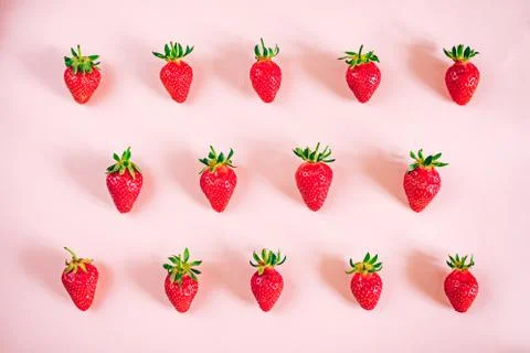 Strawberry pattern on the light pink background. Stock Photos