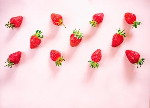 Strawberry pattern on the light pink background. Stock Photos