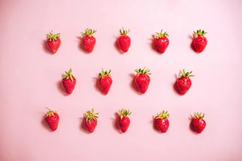 Strawberry pattern on the light pink background. Stock Photos