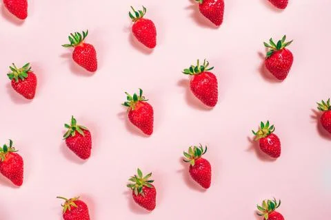 Strawberry pattern on the light pink background. Stock Photos