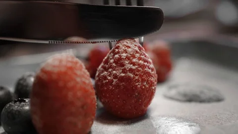 Strawberry in powder, cut into two halves. Close up appetizing food shooting Stock Footage 125364756