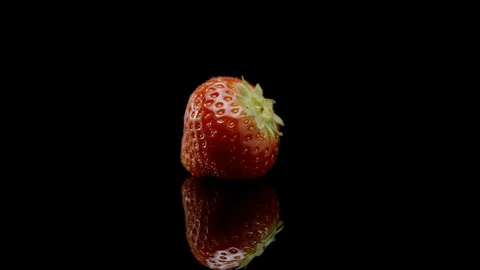 A strawberry rotating on a black background Stock Footage 128691266