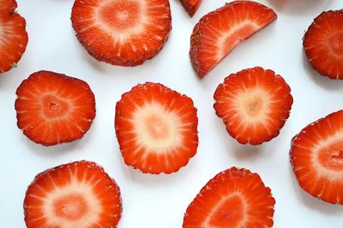 Strawberry slices as seamless pattern isolated on white background Stock Photos