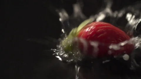 Strawberry slow motion closeup falling in water macro Stock Footage 124735080