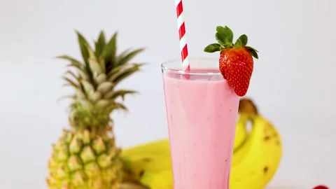 Strawberry Smoothie With Fruit Garnish and Falling Raspberries Video stock 322084877
