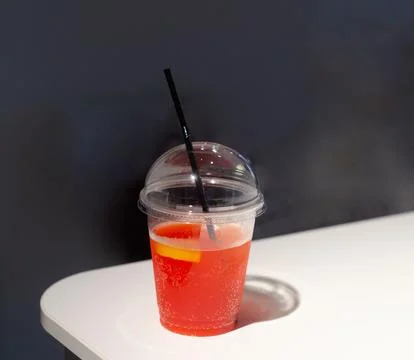 Strawberry soft drink with ice cubes and a slice of lemon Stock Photos