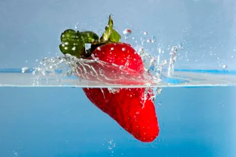 Strawberry splash in water Stock Photos