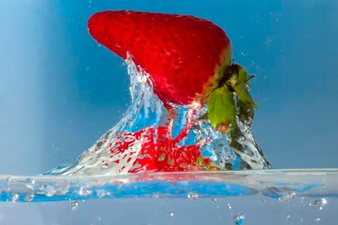 Strawberry splash in water Stock Photos