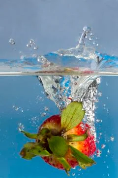 Strawberry splash in water Stock Photos