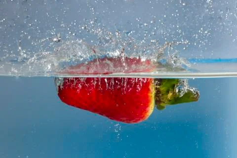 Strawberry splash in water Stock Photos
