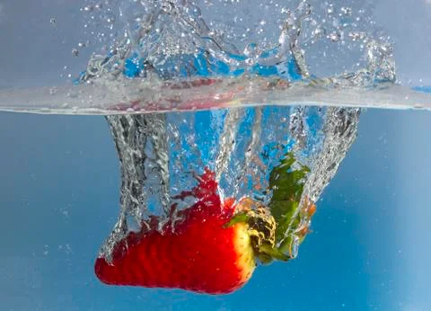Strawberry splash in water Stock Photos