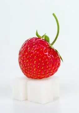 Strawberry on sugar cube Stock Photos