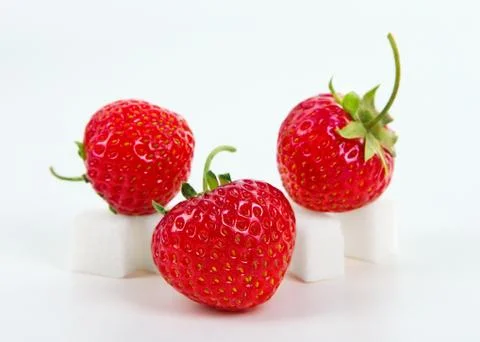 Strawberry on sugar cube Stock Photos