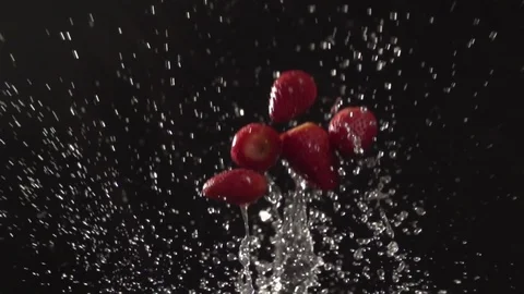 Strawberry throw up with water splash droplets slow motion closeup Stock Footage 125339802