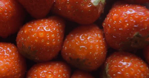 Strawberry with water drops close up studio shot over rotating Vídeo Stock 324846743