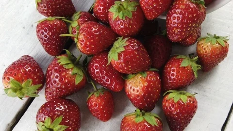 Strawberry on white table, camera rotation Stock Footage 104153236