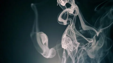 A streak of smoke falls down, creating beautiful structure on a black background Stock Footage 313160914