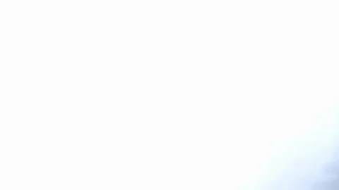 Streaking jumbo jet races through frame overhead Stock Footage 126989972