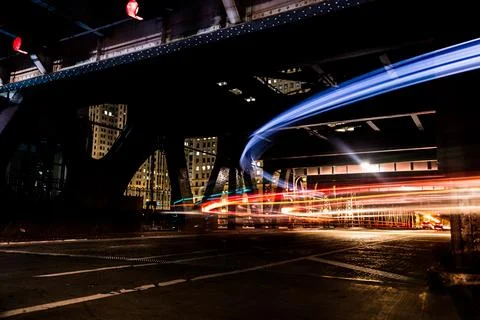 Streaks of traffic lights form pattern on city street at night in Chicago Stock Photos