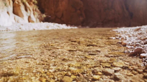 Stream And Sunlight Over Sheer Cliff Faces Of Gorge Stock Footage 146103462
