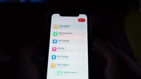 Stream of app notifications on smartphone screen in dark room close-up Stock Footage 342940715