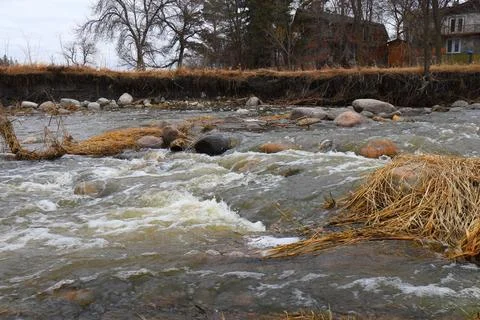 A stream between rocks and dry grass Stock Photos