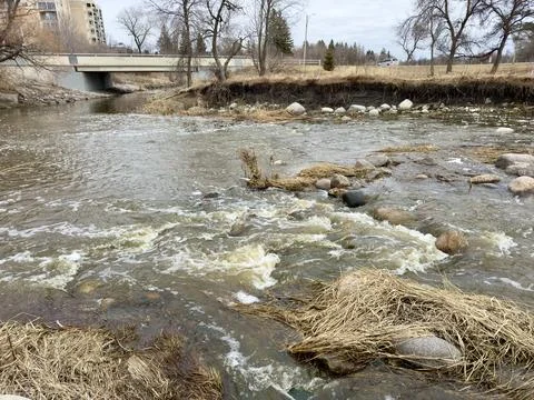 A stream between rocks and dry grass Stock Photos