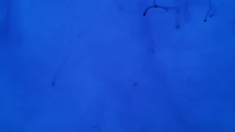 A stream of blue drops diffusing in blue fluid Stock Footage 201331308