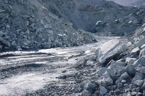 A stream at the bottom of a quarry for the extraction of stone a Stock Photos