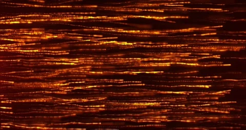 A stream of bright orange particles, a stream of glowing golden glitter dots 動画素材 248153815