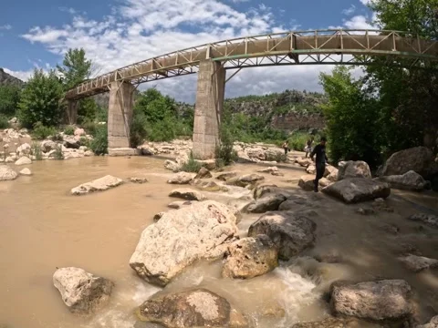 Stream of brown water on the background of the bridge Stock Footage 253333618