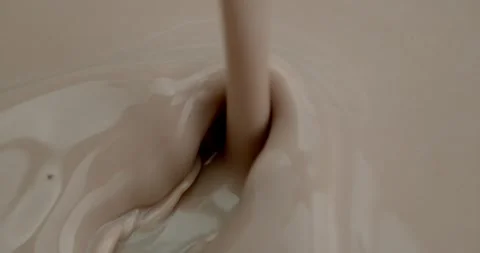 Stream of chocolate milk pours Video stock 259995264