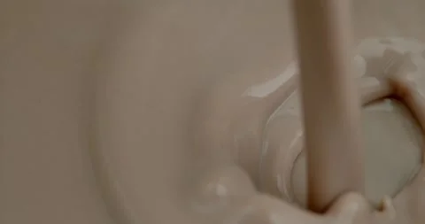 Stream of chocolate milk pours in super slow motion 스톡 동영상 259995265
