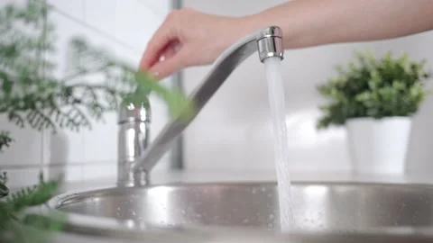 A stream of clean water drink flows into human hands. Wash hands and hygiene Video stock 197858127
