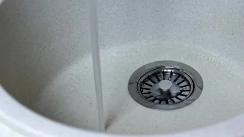 A stream of clean water flows into the ceramic sink Stock Footage 249216377