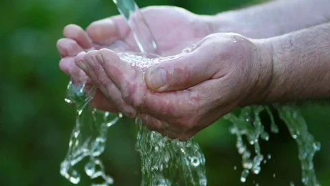 Stream of clean water pouring into man's hands Stock Footage 76349846