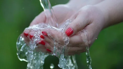Stream of clean water pouring into woman's hands Stock Footage 76349680