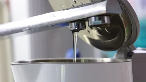 A Stream Of Clear Water Pours From A Chrome Spout, Filling An Electric Kettle. C Stock Footage 318855825