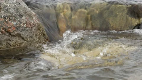 The stream of clear water in the river Stock Footage 141643110
