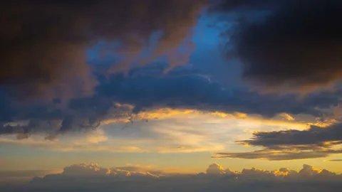The stream of clouds on the sunset background. time lapse Stock-Footage 110415356
