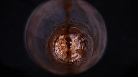 Stream of cola falls into a glass of slow mo Stock Footage 145602265