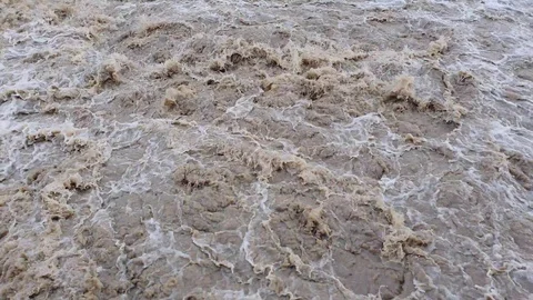 A stream of dirty bubbling muddy water Stock Footage 116593040