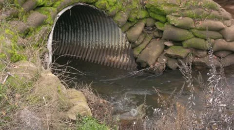 Stream entering large pipe Stock Footage 10585979