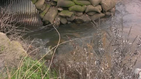 Stream enters pipe Stock Footage 10585973